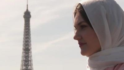 Women wearing headscarf with Eiffel Tower in background