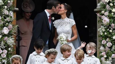 James Matthews kisses his new wife, Pippa Middleton, outside church