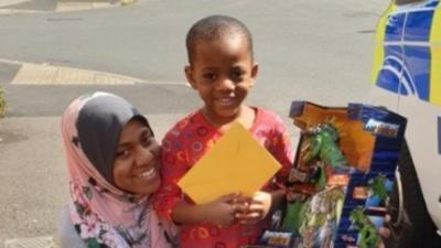 Abdullah and mum Karima with gifts