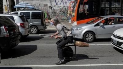 A wheeled broomstick in the middle of road traffic