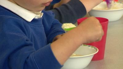 Child eating free school breakfast