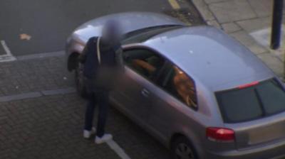 Man standing by car