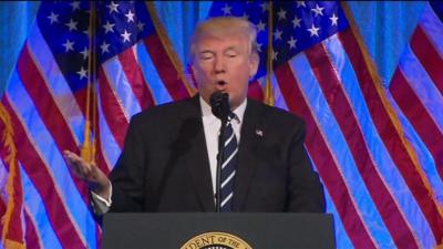 Donald Trump speaks from a lecturn