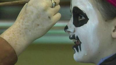 A girl having her face painted at a play scheme in 1993