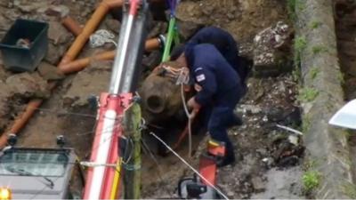 Men working to tie up the bomb