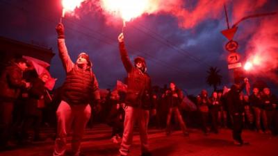 Marchers with flares in Warsaw