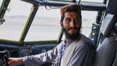 Taliban fighter poses in the cockpit of aircraft