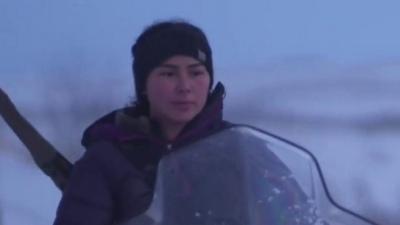 A young woman riding a snow ski