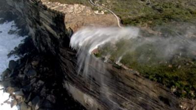 Waterfall flowing in reverse over cliff