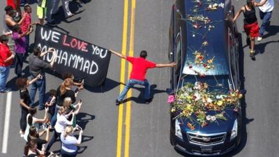 Well-wishers touch the hearse carrying the body of the late boxing champion Muhammad Ali