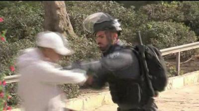 Israeli soldier clashes with young Palestinian man