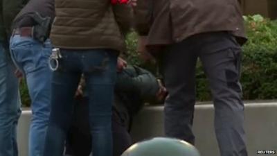 Police detain a man in the Molenbeek quarter of Brussels