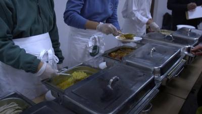 People serving curry