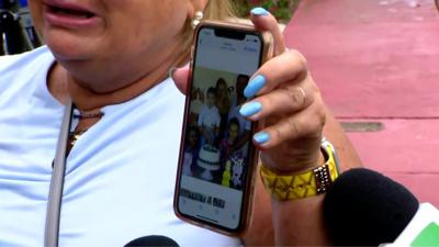 Woman holds family photo