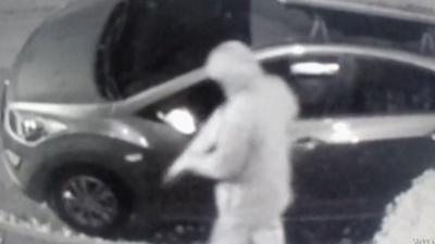 Man damaging car