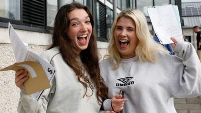 Two girls celebrate their GCSE results