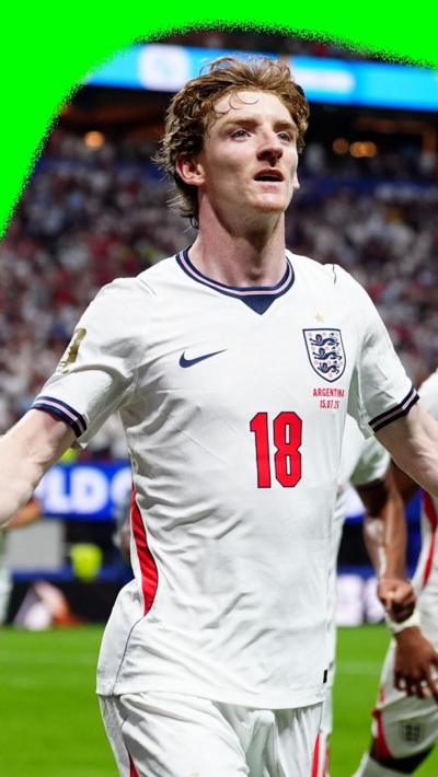 Anthony Gordon with his arm apart celebrating scoring the first goal for England against Argentina.