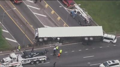 A truck hanging off freeway