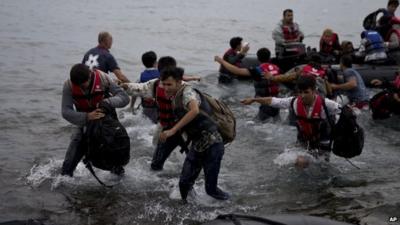 Migrants arrive on the shores of the Greek island of Lesbos after crossing the Aegean Sea from Turkey