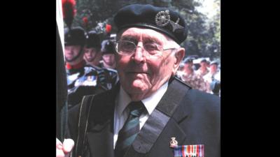 Victor Gregg wearing his medals