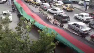 Afghan protesters mark Independence Day with the national flag, days after the Taliban takeover.