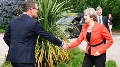 Theresa May shakes the hand of Conservative candidate for Wrexham Andrew Atkinson