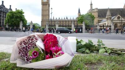 Flowers left at Parliament Square opposite the Palace of Westminster