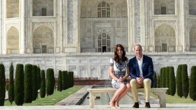 The Duke and Duchess of Cambridge pose on a bench at the Taj Mahal