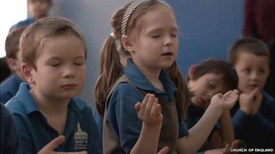 Children praying in the Church of England advert