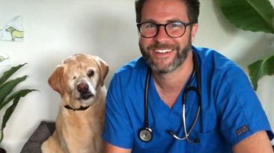 james-vet-sits-with-dog-oliver