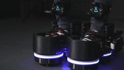 A close up of someone wearing a pair of robotic VR shoes