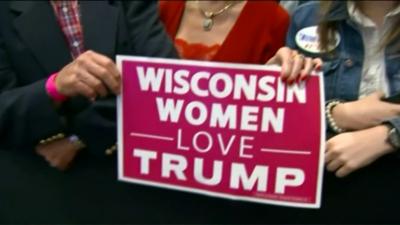 Women hold up a 'Wisconsin women love Trump" sign at a rally in Green Bay, Wisconsin - 18/10/2016