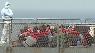 Migrants on board an Italian war ship