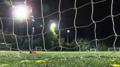 Goalkeeper standing in front of the net