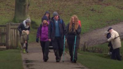 Group of ramblers walking around Lyme Park