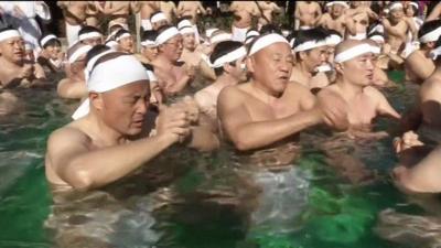 People taking an ice bath in Japan