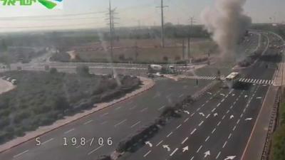 An explosion as a rocket hits a busy highway