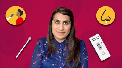 Dr Komal Badiani surrounded by the items of a lateral flow test kit