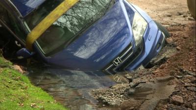 Car stuck in a sinkhole