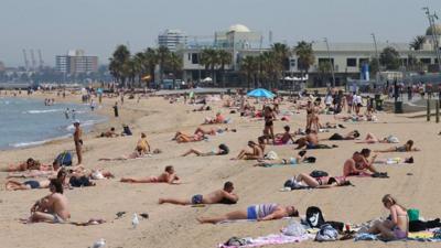 People on St Kilda beach, south of Melbourne, Australia