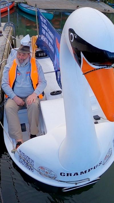 Man sat in swan pedelo