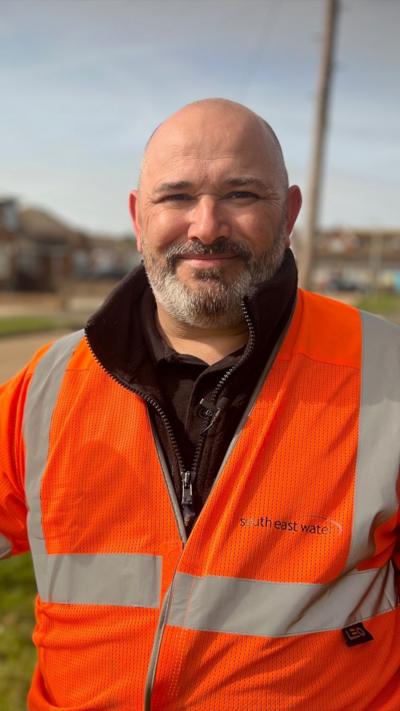 Man in high vis jacket looks at camera