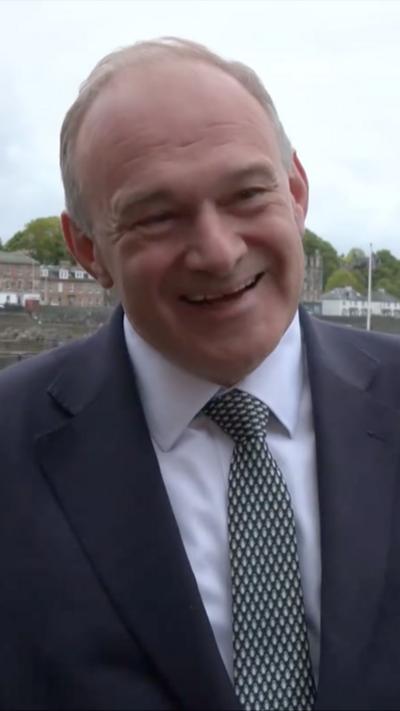 Sir Ed Davey talking to reporter in Scotland