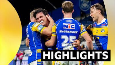 Two Leeds players hug (left) while two others stand nearby