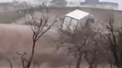 Truck about to flip over waterfall caused by flooding