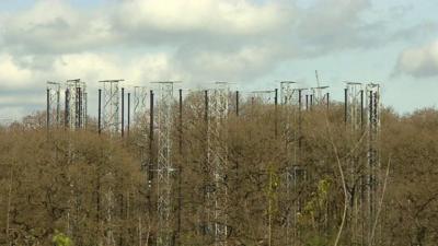 Giant masts above the forest near Stafford