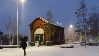 A person walking through the snow in Stoke-on-Trent