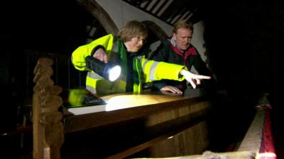 First responder shows John Maguire the flood damage at St Lawrence's Church, Appleby