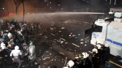 Police fire a water cannon