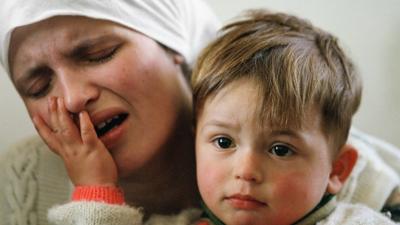 A woman cries as she mourns family members killed by Serbs in 1999